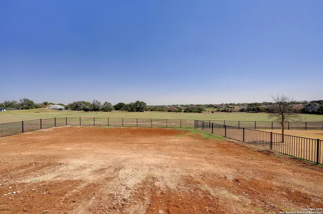 a view of house with garden and lake