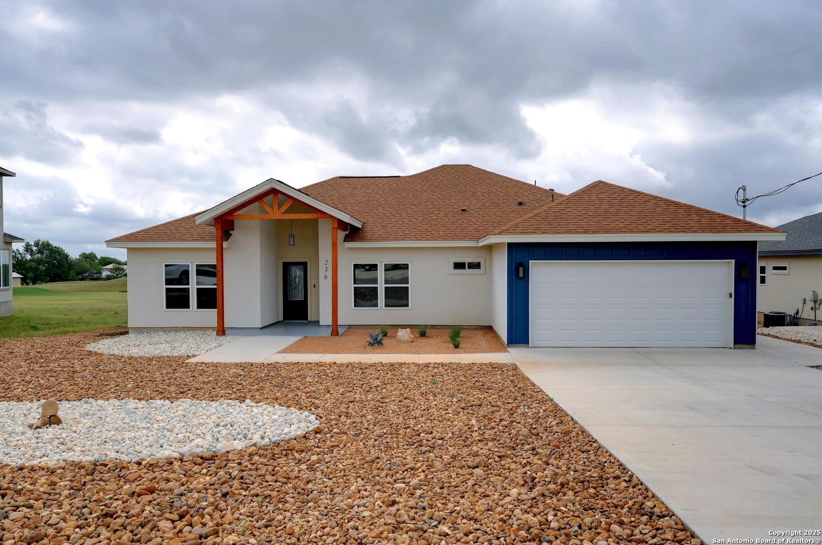 236 Peter Kleid Loop Blanco, TX 78606 - Photo 2 of 21 a front view of a house with a yard and garage