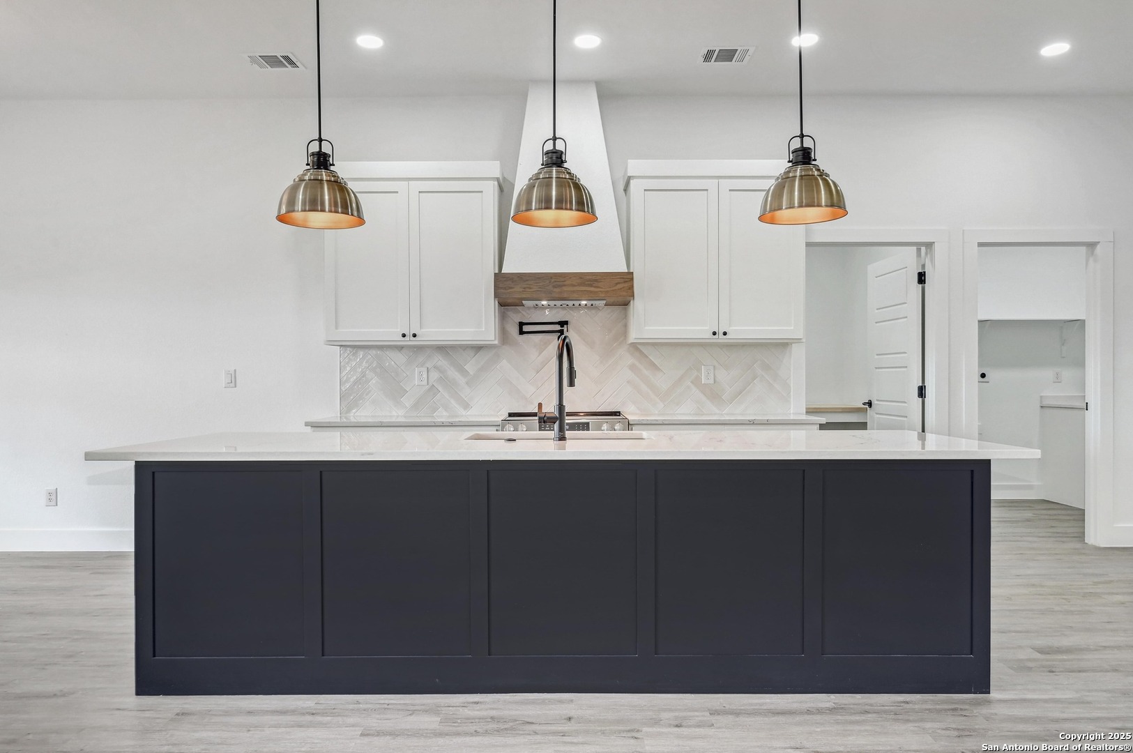 236 Peter Kleid Loop Blanco, TX 78606 - Photo 4 of 21 a kitchen with kitchen island granite countertop a sink stainless steel appliances and cabinets