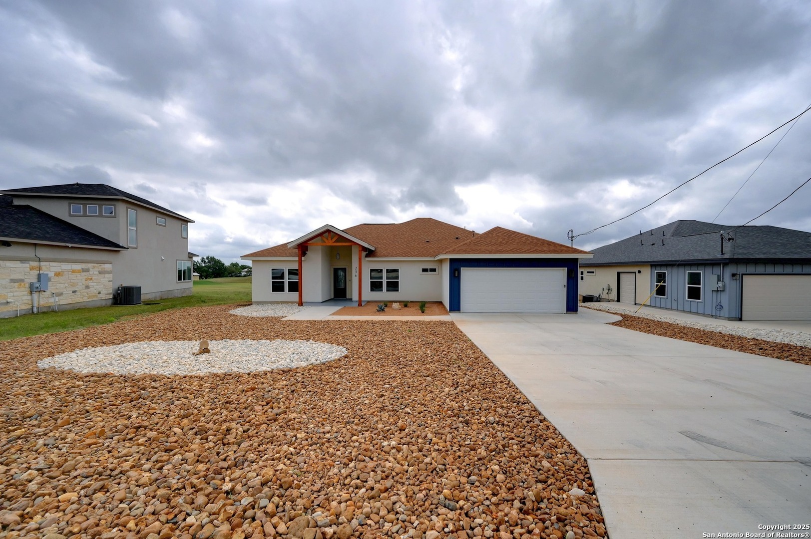236 Peter Kleid Loop Blanco, TX 78606 - Photo 4 of 21 a front view of a house with a yard and garage
