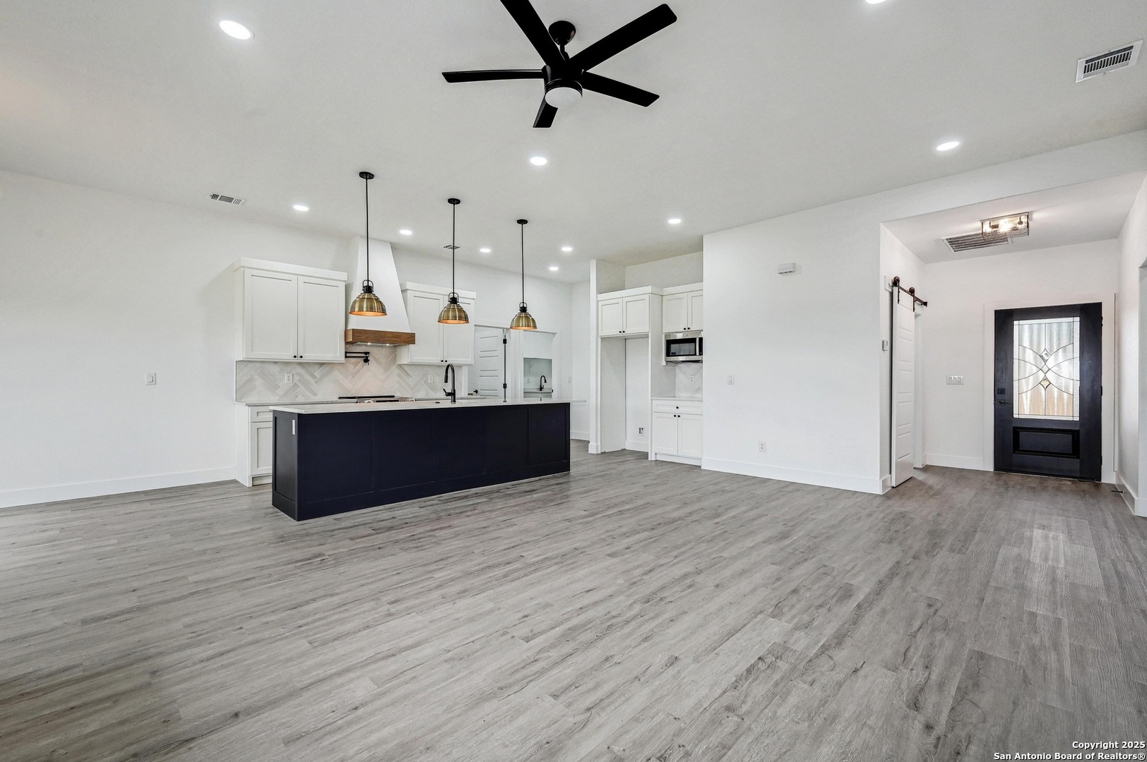 236 Peter Kleid Loop Blanco, TX 78606 - Photo 8 of 21 a view of kitchen and sink with wooden floor