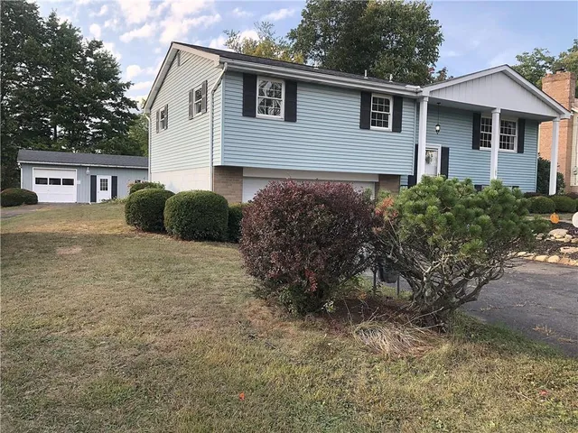 a view of a house with a yard and plants