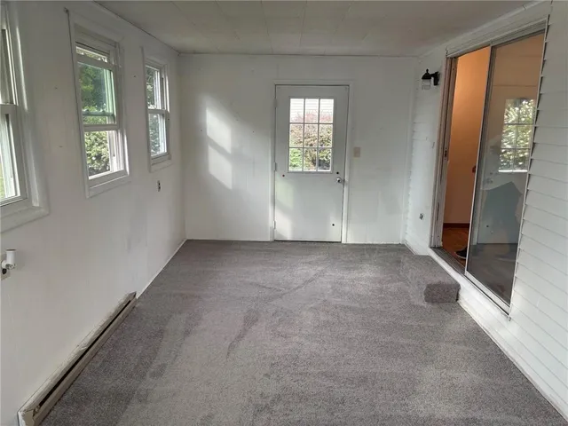 an empty room with windows and closet