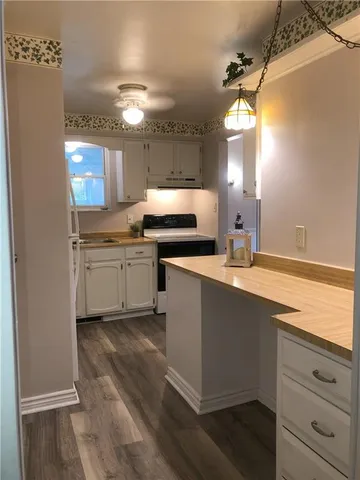 a kitchen with a sink stainless steel appliances and cabinets