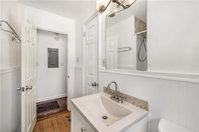 a bathroom with a sink a toilet and shower