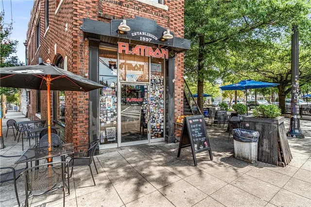 a view of a chairs and tables in patio with a barbeque