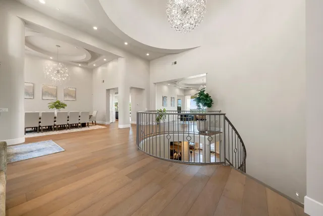 a kitchen with stainless steel appliances kitchen island granite countertop a sink a stove a microwave a dining table and chairs