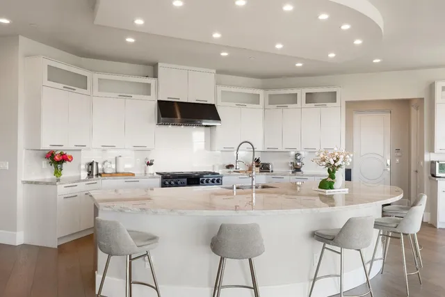 a kitchen with stainless steel appliances granite countertop a sink and a refrigerator