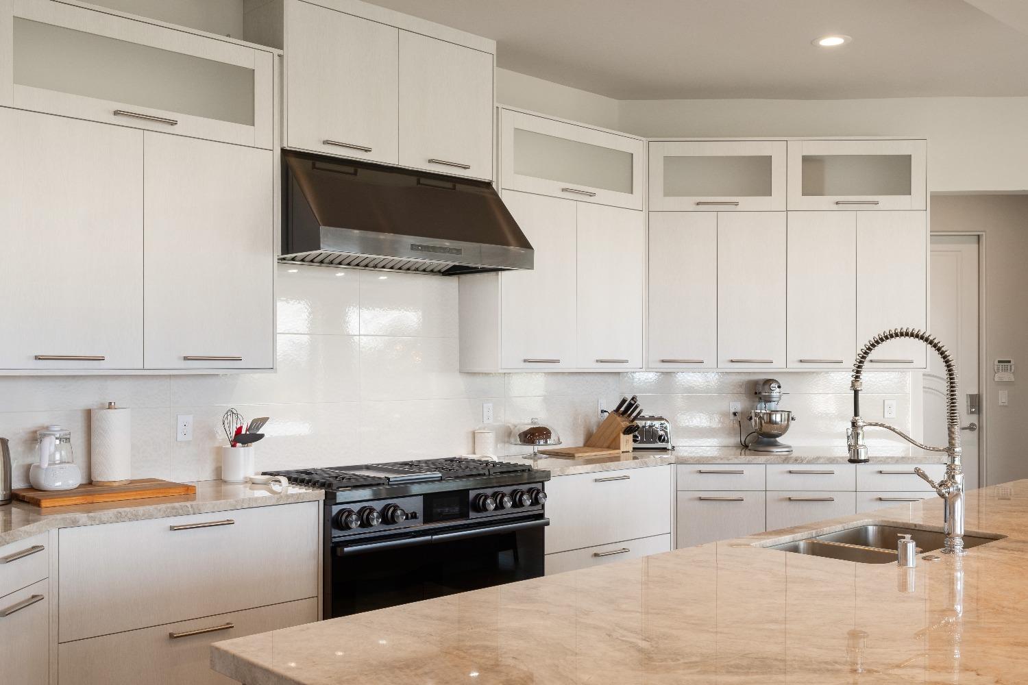 4023 Cornwall Court Rocklin, CA 95677 - Photo 22 of 85 a kitchen with stainless steel appliances kitchen island a stove a sink and white cabinets