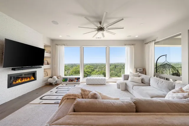 a view of roof deck with couches and sky view