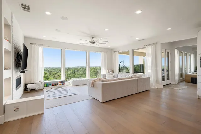 a living room with furniture and a floor to ceiling window