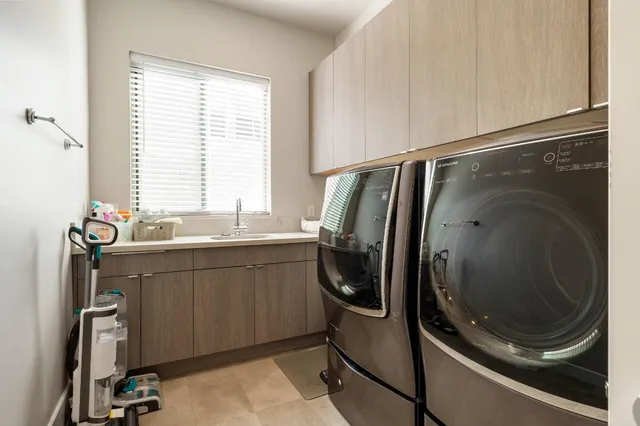 a view of a livingroom with a flat screen tv and kitchen view