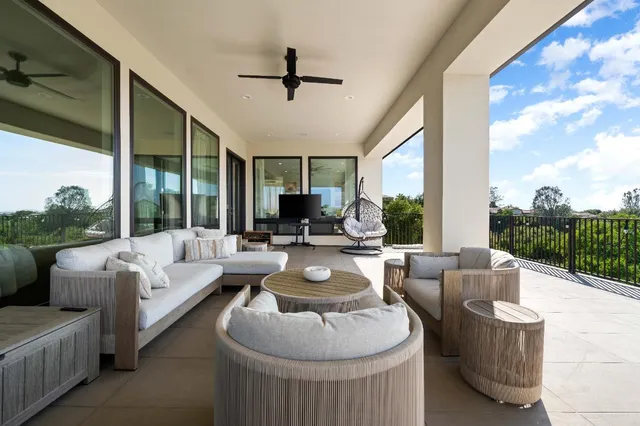 a living room with furniture or chandelier and a wooden floor