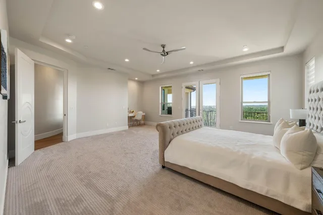 a spacious bedroom with a bed and a chandelier