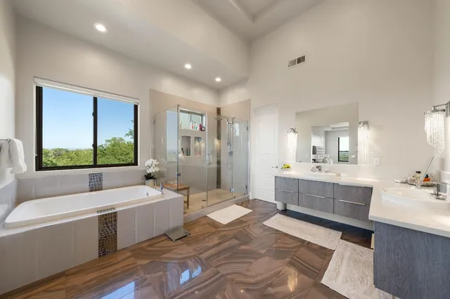 a bathroom with a sink vanity mirror bathtub and toilet