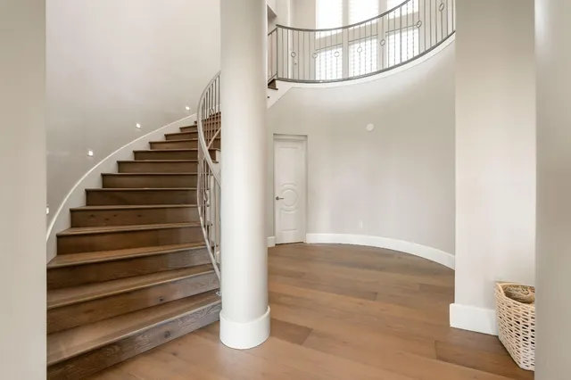 an aerial view of a house with yard and balcony