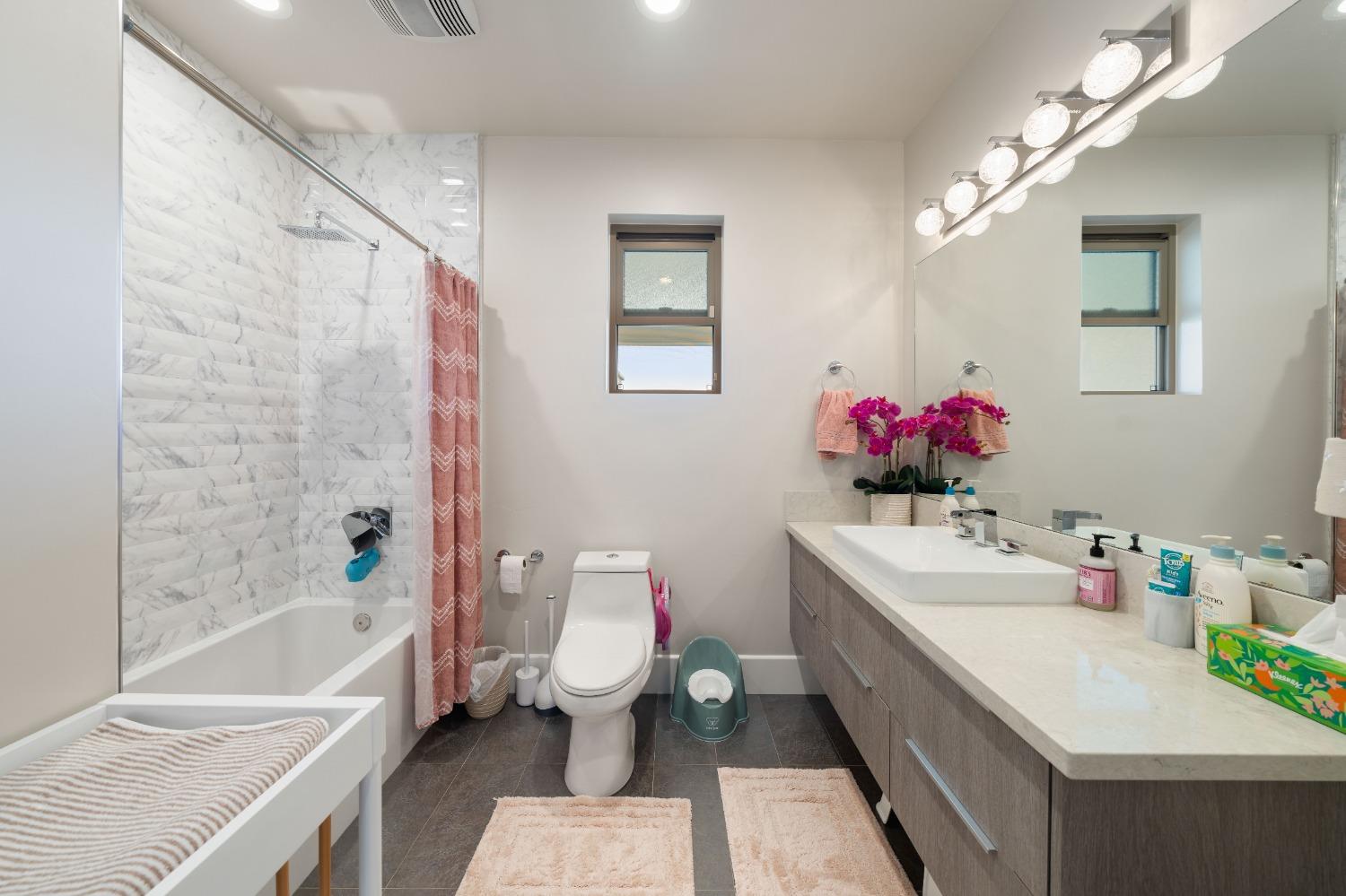 4023 Cornwall Court Rocklin, CA 95677 - Photo 64 of 85 a bathroom with a sink vanity mirror bathtub and toilet