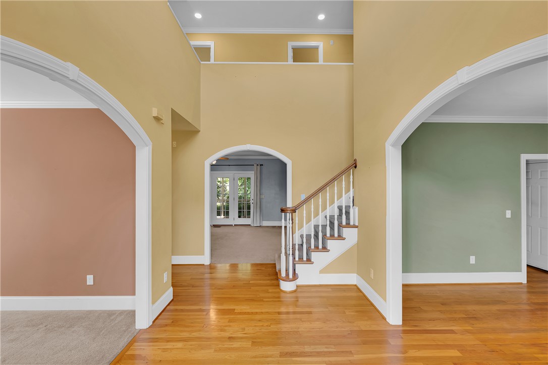406 Hopewell Ridge Anderson, SC 29621 - Photo 4 of 46 Enter into a grand foyer featuring a beautiful staircase and polished hardwood floors.