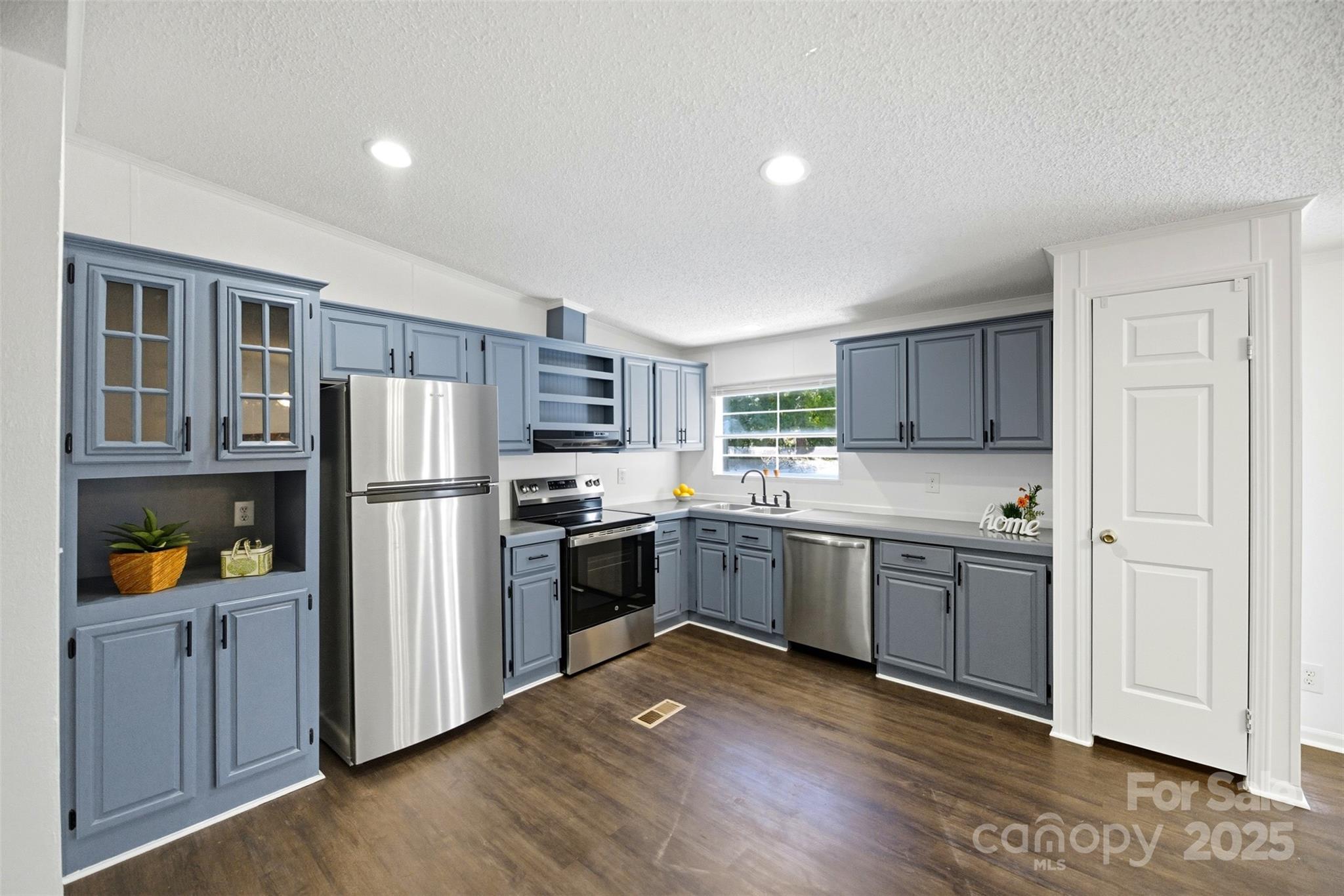2319 Alexis Lucia Road Stanley, NC 28164 - Photo 6 of 32 a kitchen with stainless steel appliances granite countertop a refrigerator and a stove top oven