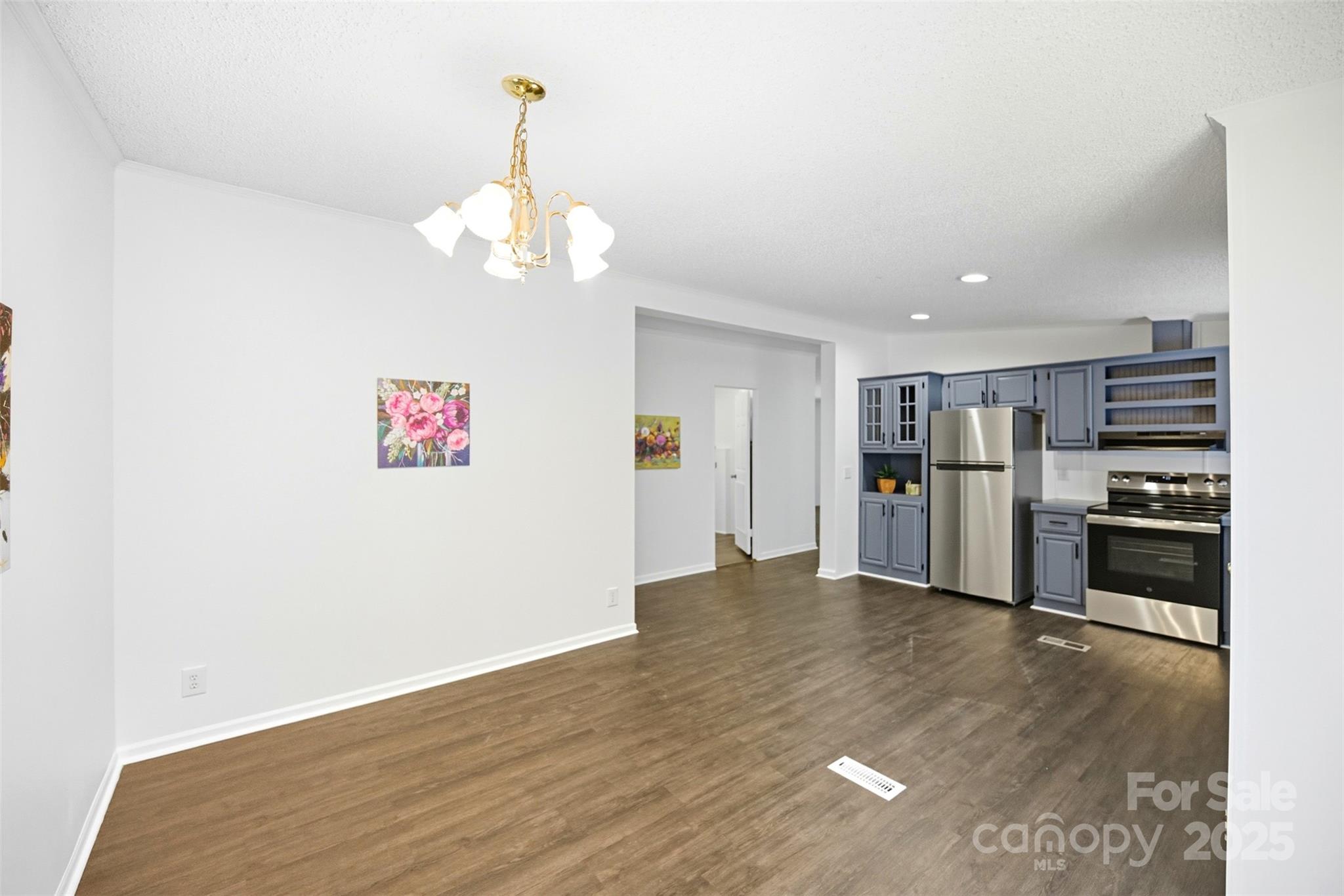 2319 Alexis Lucia Road Stanley, NC 28164 - Photo 8 of 32 a view of a kitchen with a sink refrigerator and wooden floor