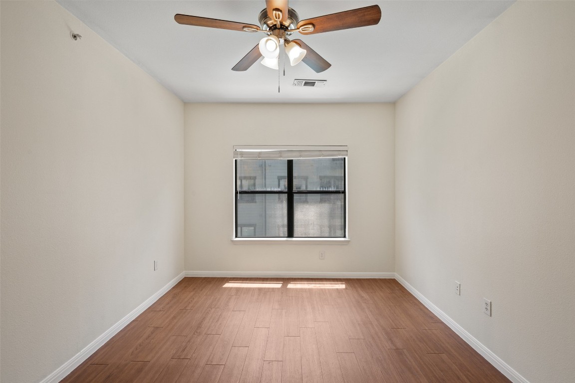 2502 Leon Street, Unit 417 Austin, TX 78705 - Photo 17 of 30 an empty room with a window and wooden floor