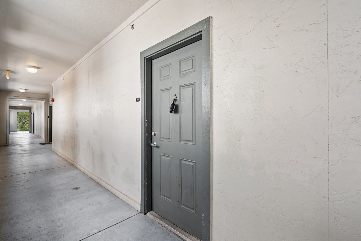 2502 Leon Street, Unit 417 Austin, TX 78705 - Photo 3 of 30 a view of a hallway with wooden floor