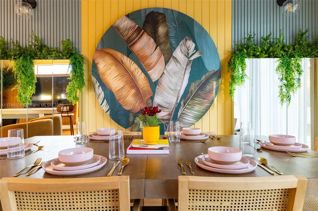 a dining room with furniture and a potted plant