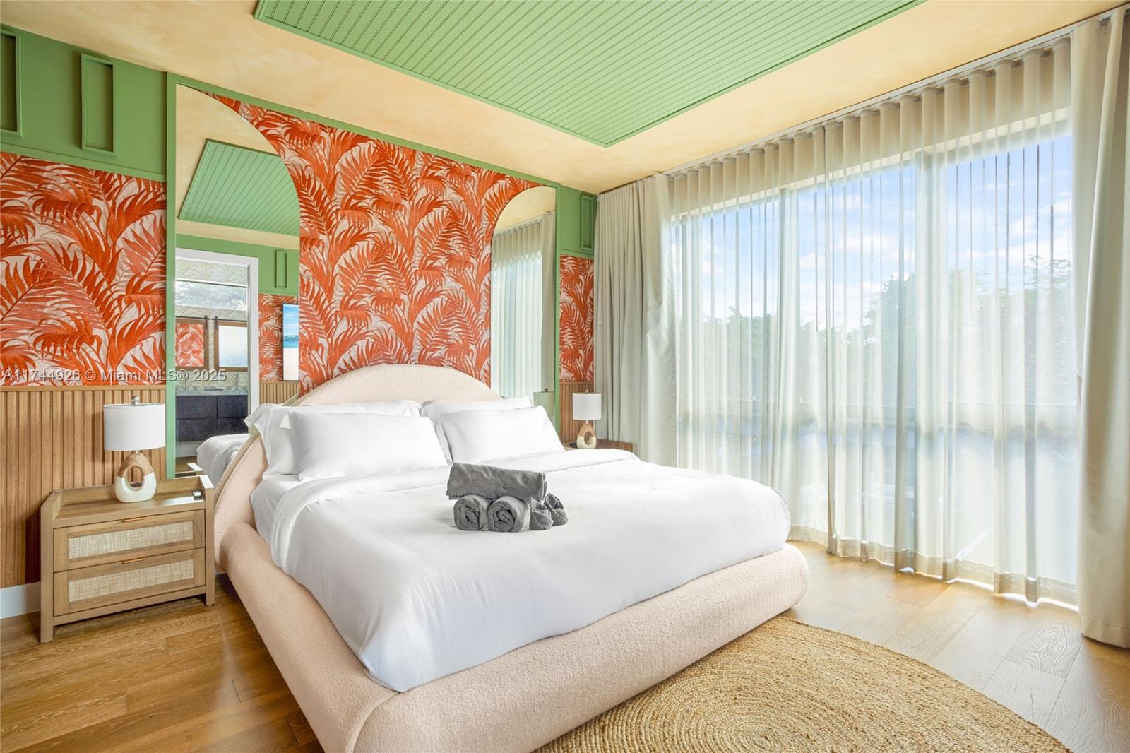 416 Northwest 52nd Street Miami, FL 33127 - Photo 10 of 70 a large white bed in a small room next to a window