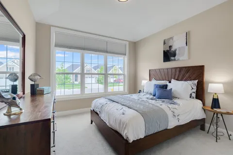a bedroom with a large bed and a window