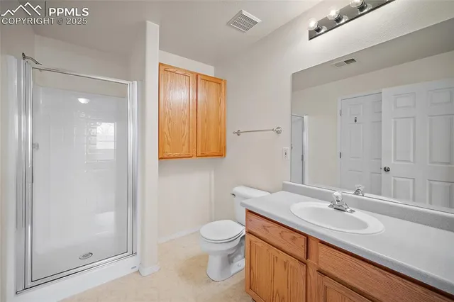 a bathroom with a toilet sink a mirror and shower