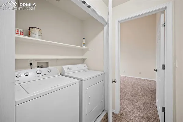 a view of storage and utility room with washer and dryer