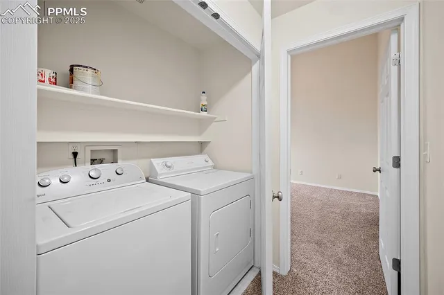 a view of storage and utility room with washer and dryer