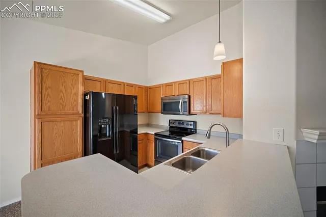 a kitchen with stainless steel appliances a refrigerator a stove a sink and a refrigerator
