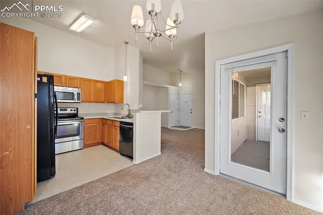 a large kitchen with cabinets and stainless steel appliances