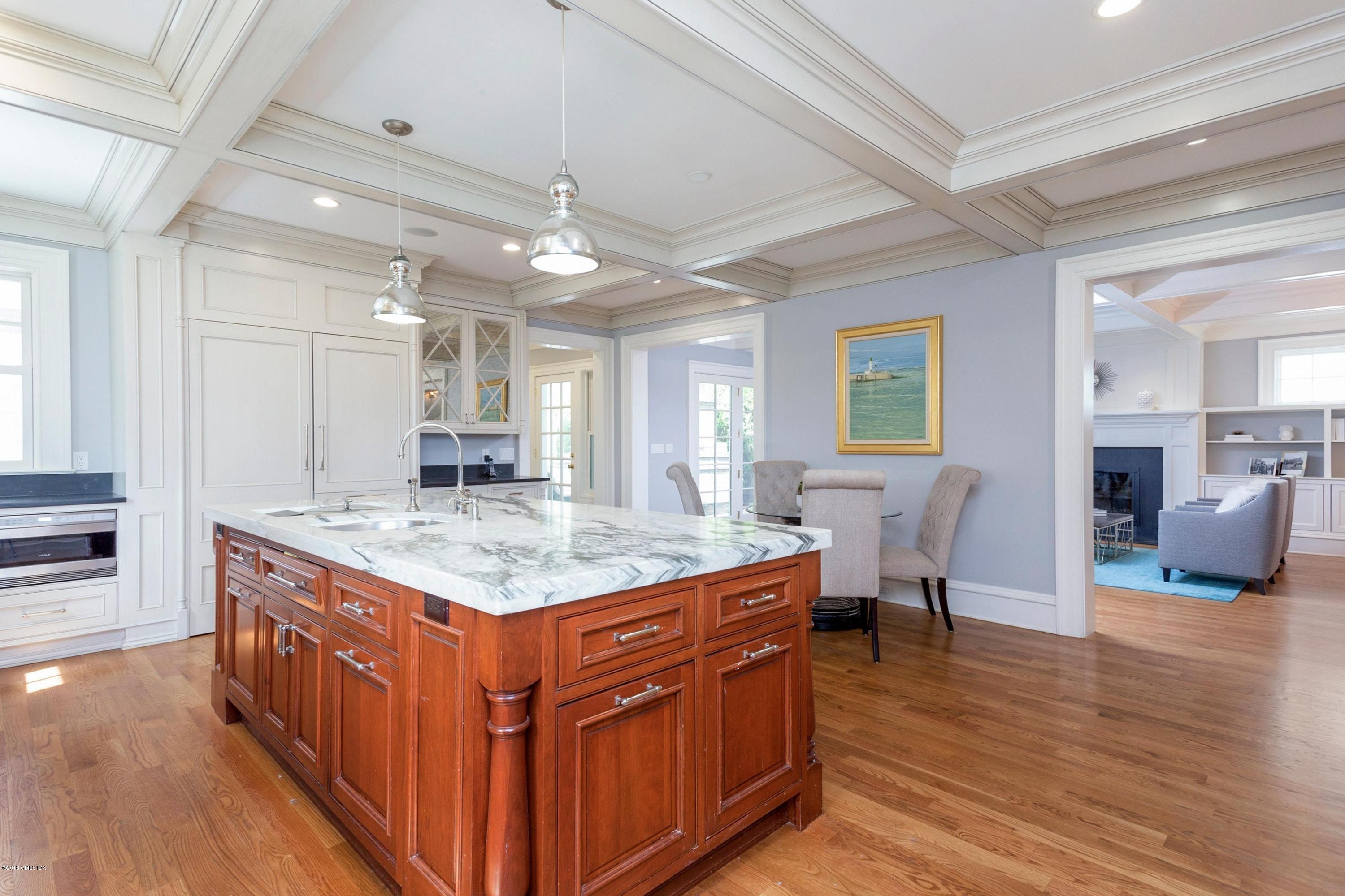 58 Ridge Street Greenwich, CT 06830 - Photo 14 of 29 a kitchen with stainless steel appliances granite countertop a kitchen island a stove a sink a dining table and chairs