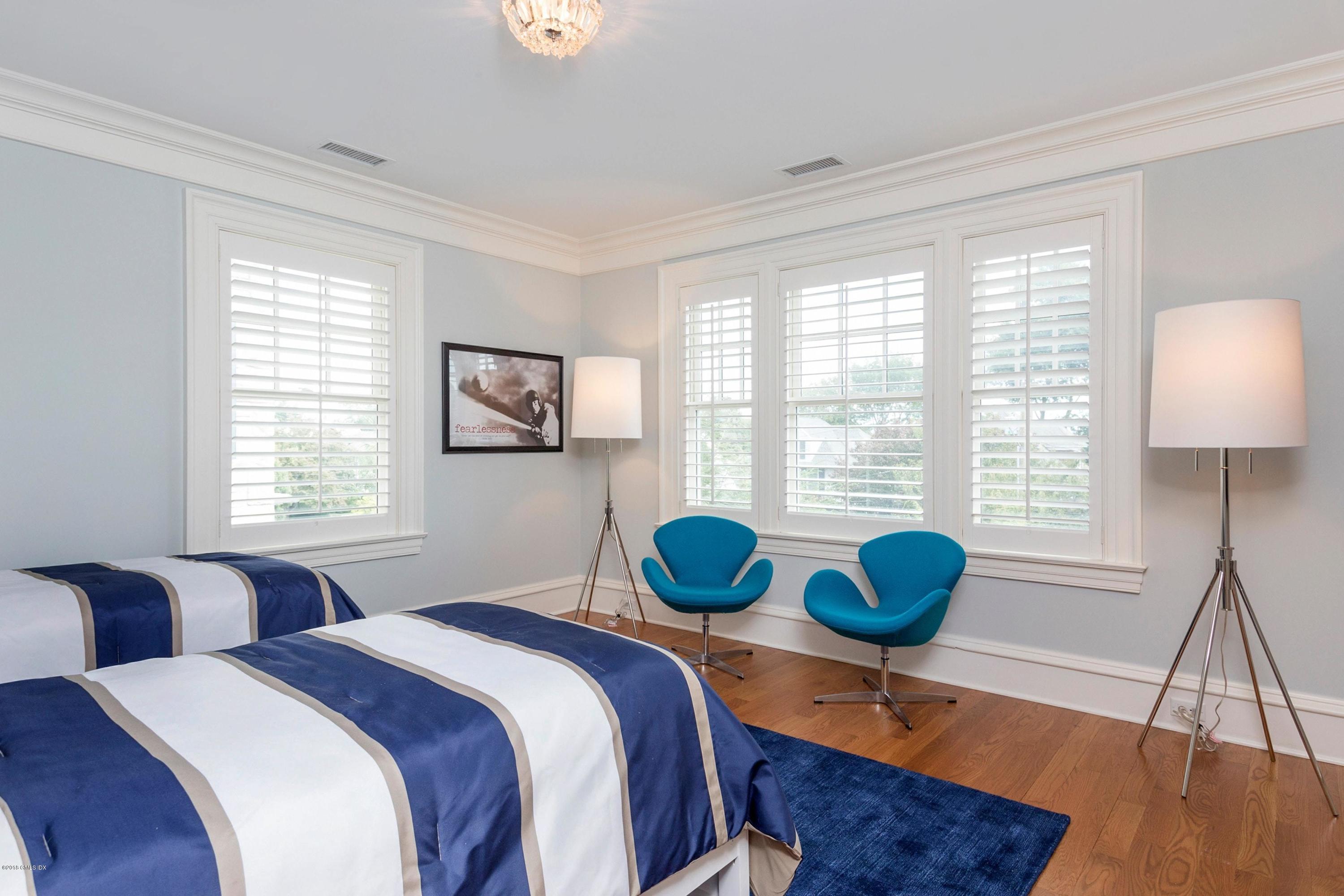 58 Ridge Street Greenwich, CT 06830 - Photo 18 of 29 a bedroom with two beds a bed and a window