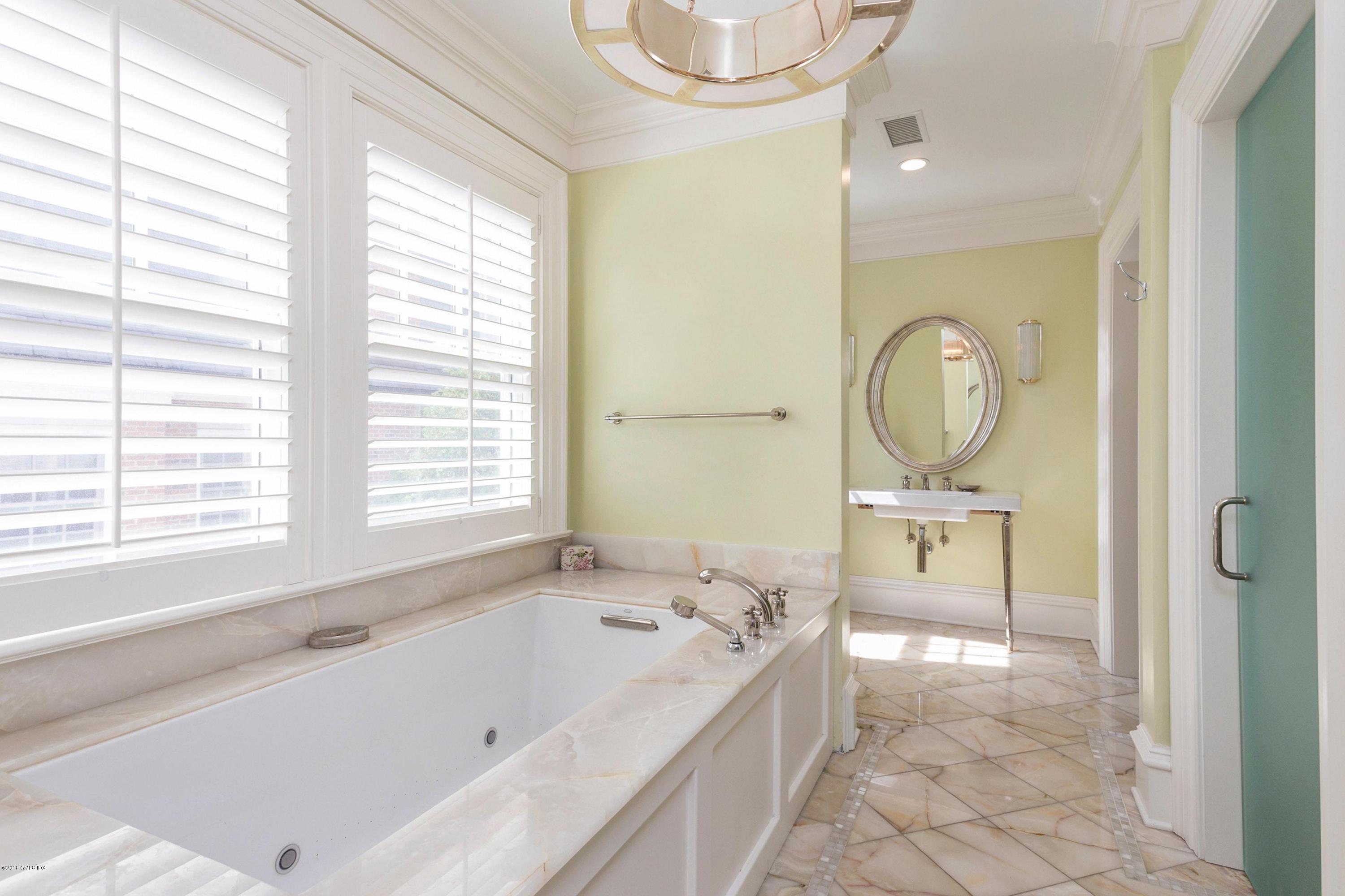 58 Ridge Street Greenwich, CT 06830 - Photo 21 of 29 a bathroom with a bathtub and a sink