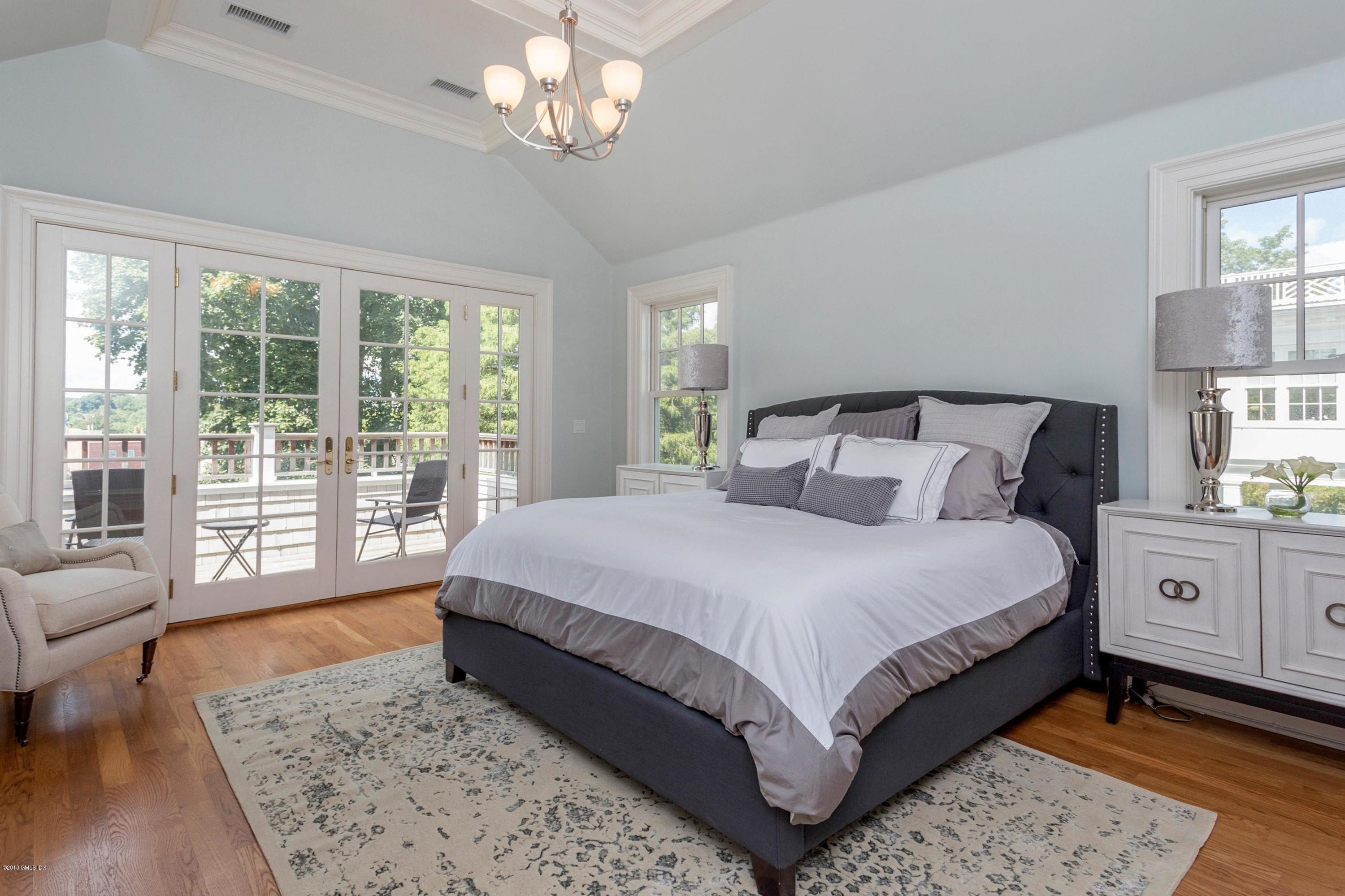 58 Ridge Street Greenwich, CT 06830 - Photo 23 of 29 a bedroom with a large bed and a couch