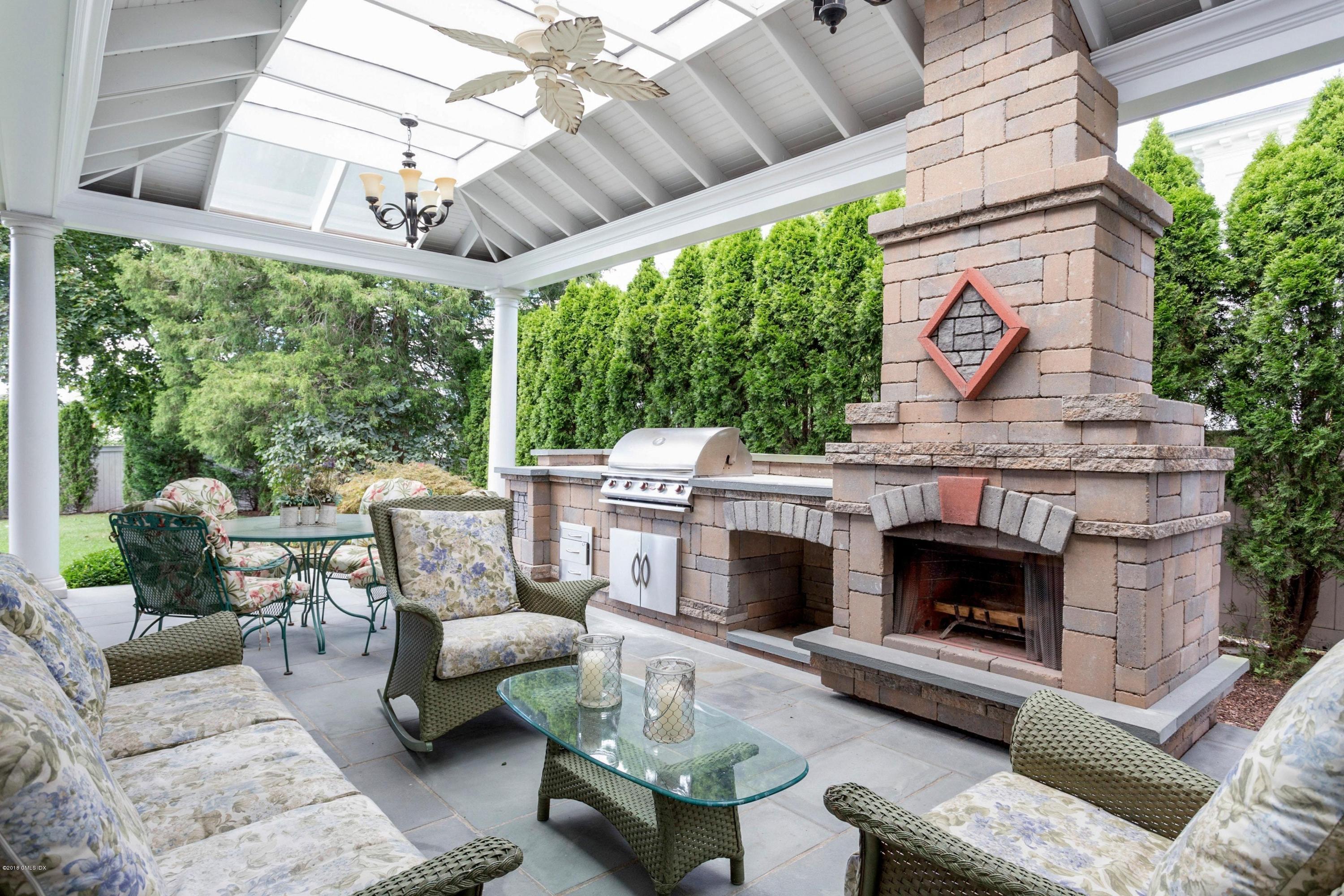 58 Ridge Street Greenwich, CT 06830 - Photo 25 of 29 a outdoor space with patio fireplace couches and a potted plant