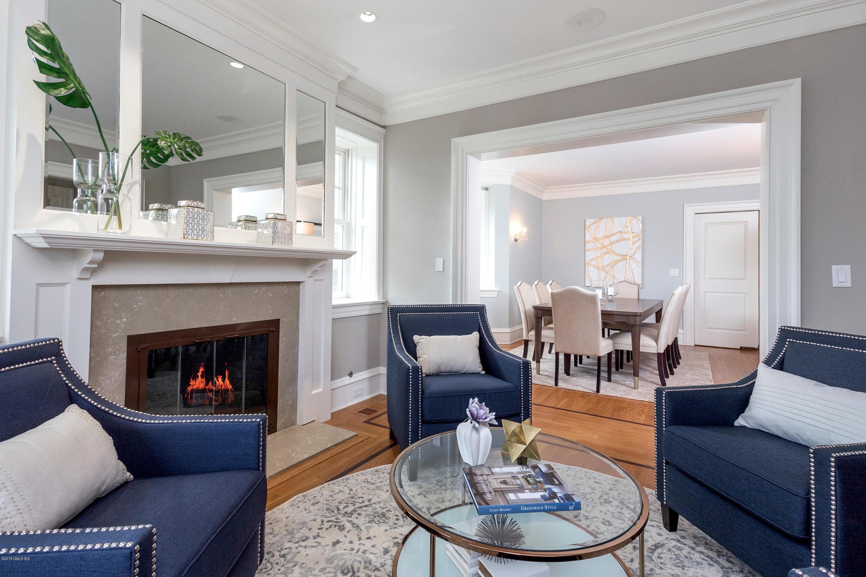 58 Ridge Street Greenwich, CT 06830 - Photo 7 of 29 a living room with furniture a fireplace and a table