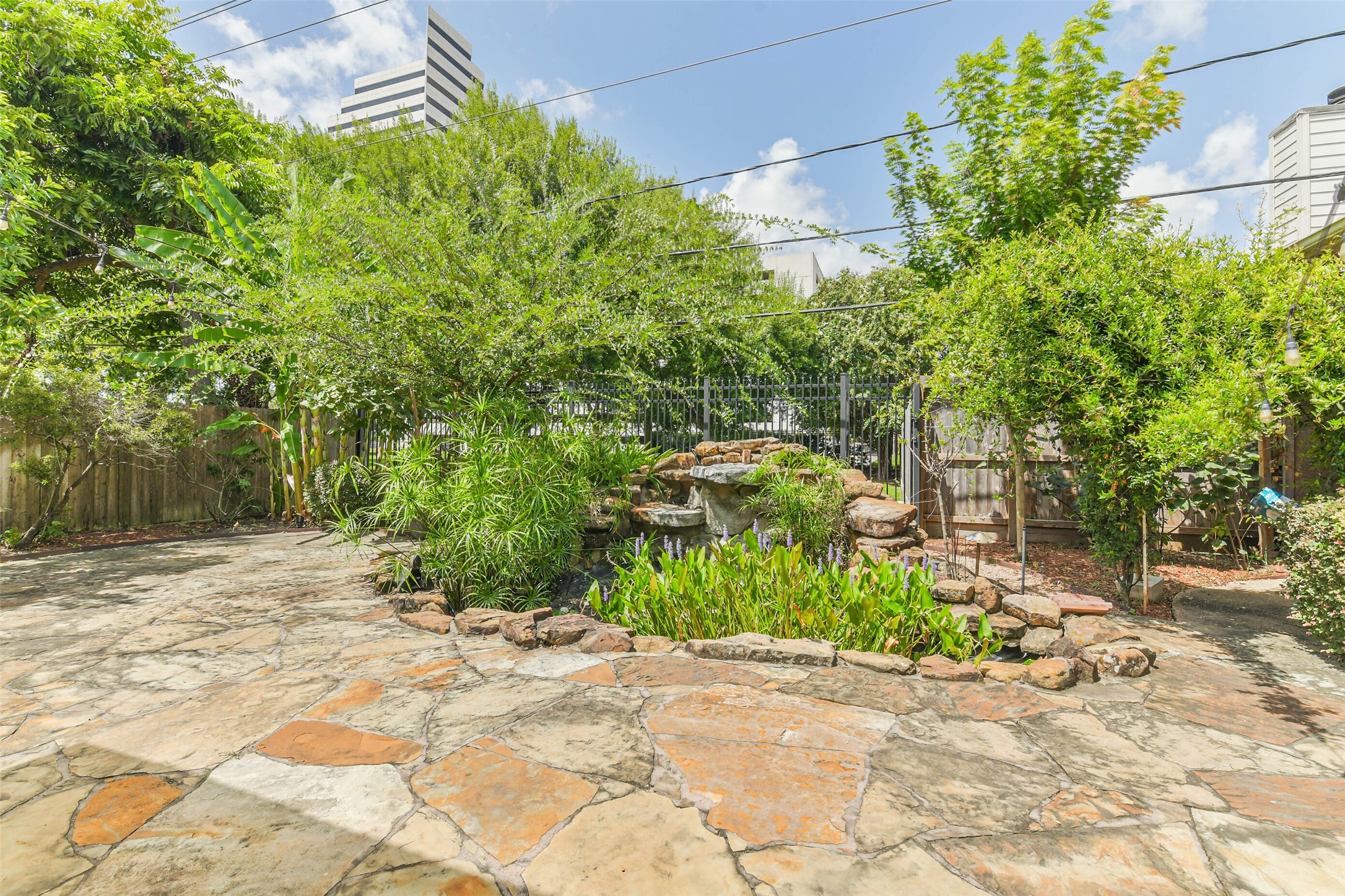 Lush green space behind the backyard, offering a peaceful and private view