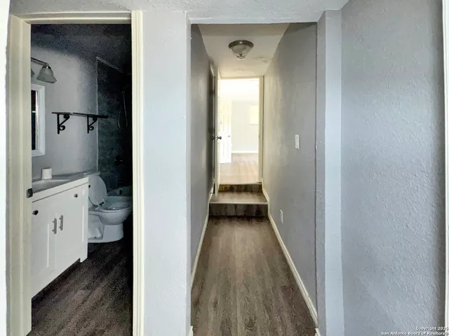 a view of a bathroom from a hallway