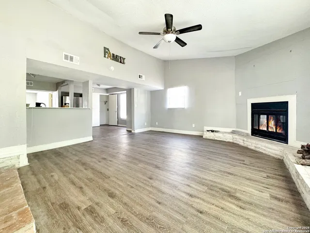 a view of a room wooden floor and window