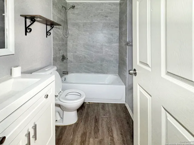 a bathroom with a sink a toilet and a bathtub