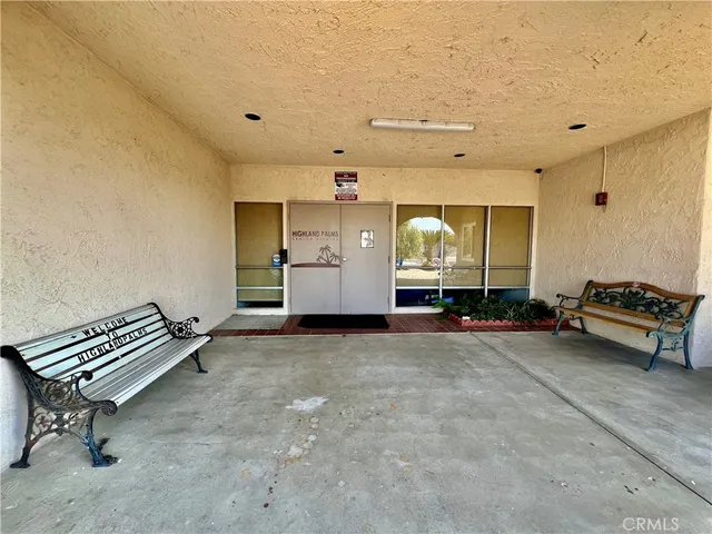 a living room with furniture and a book shelf