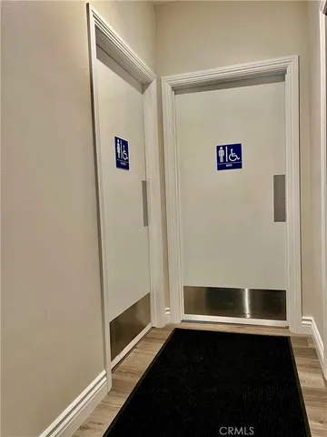 a front view of a house with a yard and potted plants