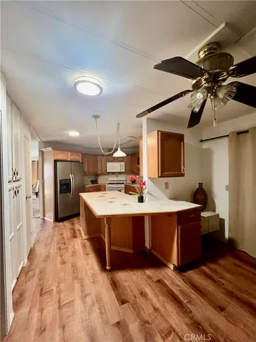 a view of kitchen with stainless steel appliances granite countertop sink stove and refrigerator
