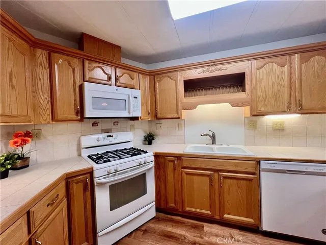 a kitchen with stainless steel appliances a stove a sink and a microwave