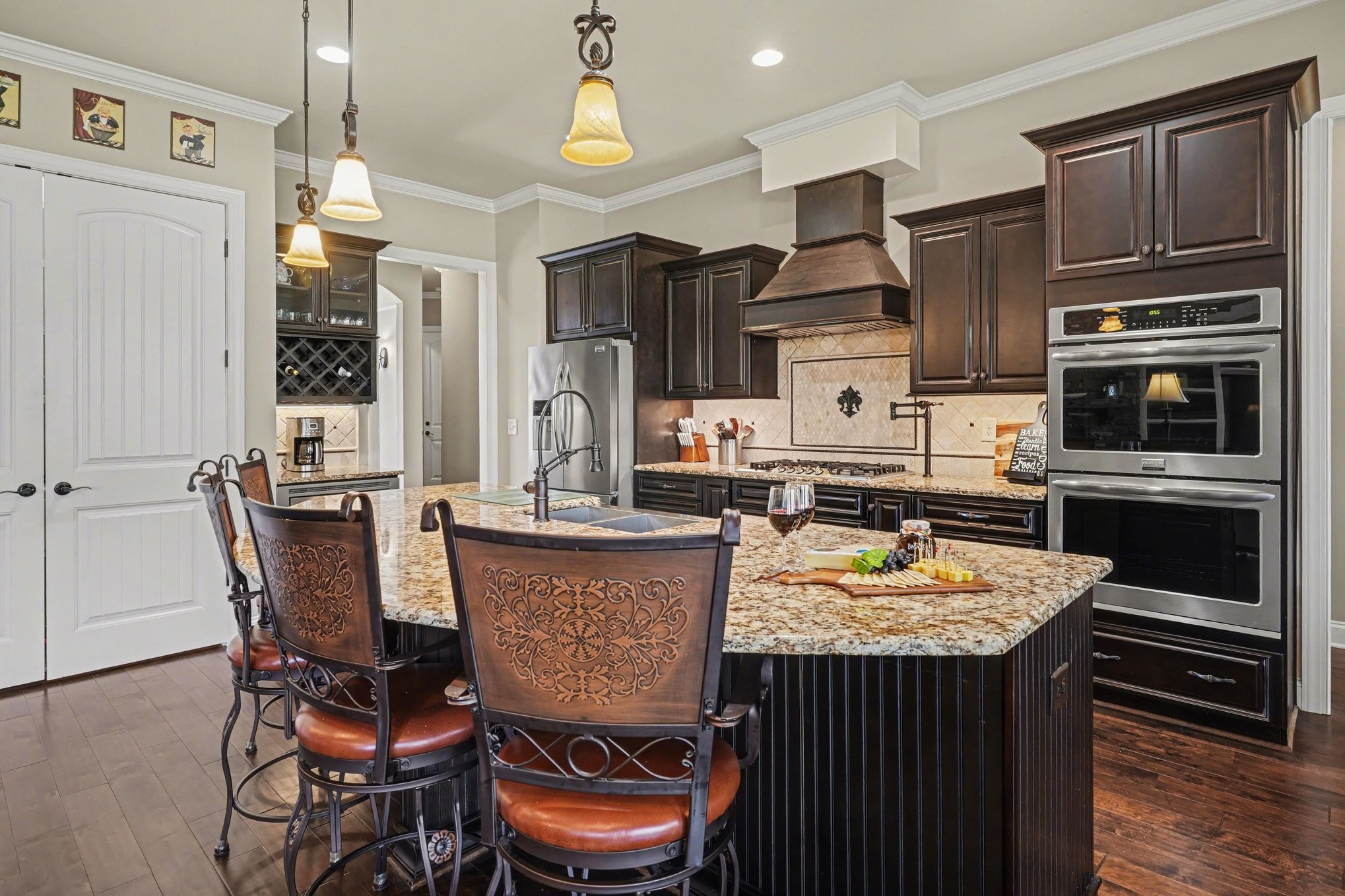 5094 Moss Road Nashville, TN 37221 - Photo 12 of 29 a kitchen with a stove a refrigerator and a dining table with wooden floor
