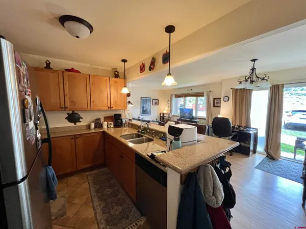 a living room with lots of furniture and kitchen view
